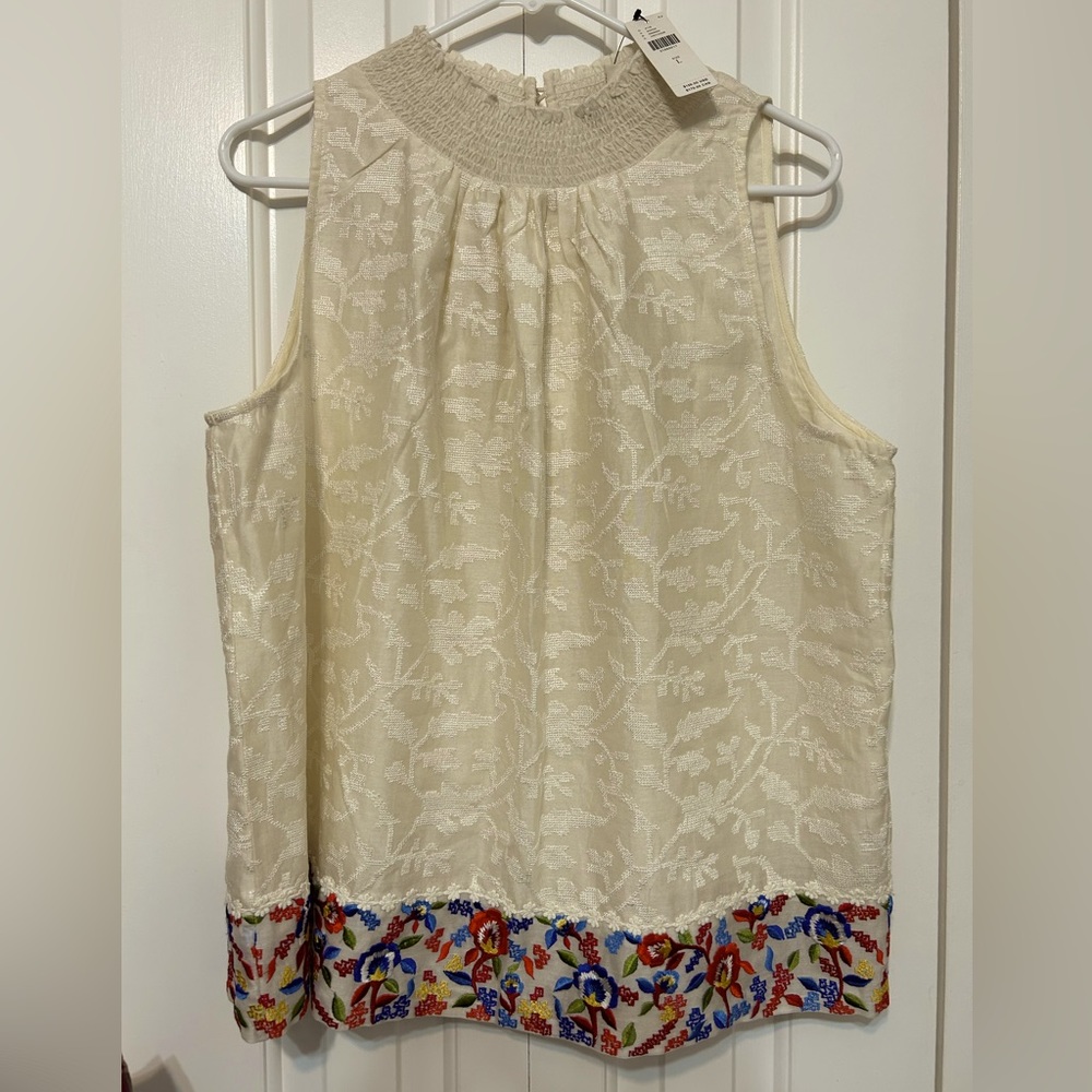 Embroidered sleeveless top.